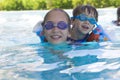 Happy Girl and Boy Enjoying in Swimming Pool Royalty Free Stock Photo