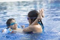 Happy Girl and Boy Enjoying in Swimming Pool Royalty Free Stock Photo