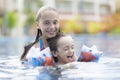 Happy Girl and Boy Enjoying in Swimming Pool Royalty Free Stock Photo