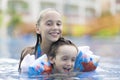 Happy Girl and Boy Enjoying in Swimming Pool Royalty Free Stock Photo