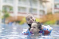 Happy Girl and Boy Enjoying in Swimming Pool Royalty Free Stock Photo