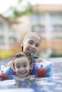 Happy Girl and Boy Enjoying in Swimming Pool Royalty Free Stock Photo