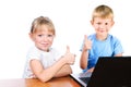 Happy girl and boy at laptop with thump up sign Royalty Free Stock Photo