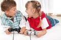 Happy girl and boy playing a video game Royalty Free Stock Photo