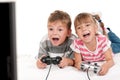 Happy girl and boy playing a video game Royalty Free Stock Photo