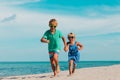 Happy girl and boy run at beach, kids play on vacation Royalty Free Stock Photo