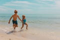 Kids- girl and boy run play with waves on beach Royalty Free Stock Photo