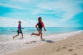 Happy girl and boy run and play with water at beach Royalty Free Stock Photo