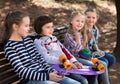 Happy girl and boy sitting in the park on a bench in spring Royalty Free Stock Photo