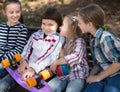 Happy girl and boy sitting in park on bench in spring Royalty Free Stock Photo