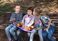 Happy girl and boy sitting in the park on a bench in spring Royalty Free Stock Photo