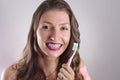 Happy girl with braces holding toothbrush