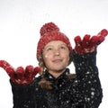 Happy girl catching snow flakes in her hand