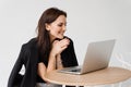 Happy girl chatting with family and friends via video call on white background. Successful business woman with laptop Royalty Free Stock Photo