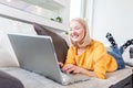 Happy girl chatting online on laptop. Smiling blonde woman messaging with friends on computer. Social media, communication and