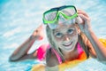 Happy girl child playing in the pool on a sunny day. Cute little girl enjoying holiday vacation Royalty Free Stock Photo