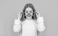 Happy girl child smiling in big funny heart-shaped glasses blue background Royalty Free Stock Photo