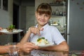 Happy girl chose one dish out of two offered by her mother for lunch