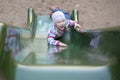 Happy girl climbing on children's slide Royalty Free Stock Photo