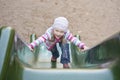 Happy girl climbing on children's slide Royalty Free Stock Photo