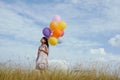 Happy girl with colorful balloons