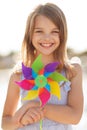 Happy girl with colorful pinwheel toy Royalty Free Stock Photo