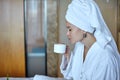 Happy Girl with a Cup of Coffee. Home Style Relaxation Woman Wearing Bathrobe and Towel after Shower. Spa Good Morning Royalty Free Stock Photo