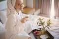 Happy Girl with a Cup of Coffee. Home Style Relaxation Woman Wearing Bathrobe and Towel after Shower. Spa Good Morning Royalty Free Stock Photo