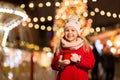 Happy girl with cup of tea at christmas market Royalty Free Stock Photo