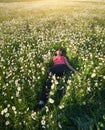 Girl in daisy wheel spring flower field