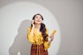 Happy girl dancing and listening to the music  on a white background Royalty Free Stock Photo