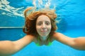 Happy girl dive underwater with fun in swimming pool Royalty Free Stock Photo