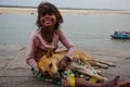 Happy girl with dog. Varanasi, India