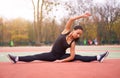 Happy girl doing fitness exercises outdoor on playground. Healthy lifestyle. Morning workout positive emotion smiling sportive Royalty Free Stock Photo