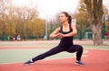 Happy girl doing fitness exercises outdoor on playground. Healthy lifestyle. Morning workout positive emotion smiling sportive Royalty Free Stock Photo