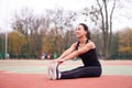 Happy girl doing fitness exercises outdoor on playground. Healthy lifestyle. Morning workout positive emotion smiling sportive Royalty Free Stock Photo