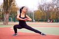 Happy girl doing fitness exercises outdoor on playground. Healthy lifestyle. Morning workout positive emotion smiling sportive Royalty Free Stock Photo