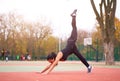 Happy girl doing fitness exercises outdoor on playground. Healthy lifestyle. Morning workout positive emotion smiling sportive Royalty Free Stock Photo