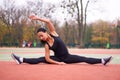 Happy girl doing fitness exercises outdoor on playground. Healthy lifestyle. Morning workout positive emotion smiling sportive Royalty Free Stock Photo