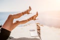 Woman sea laptop. Business woman in yellow hat freelancer with laptop working over blue sea beach. Girl relieves stress Royalty Free Stock Photo