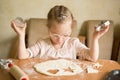 Happy girl with Down syndrome bakes cookies Royalty Free Stock Photo