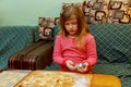 Happy girl with Down syndrome bakes cookies Royalty Free Stock Photo