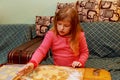 Happy girl with Down syndrome bakes cookies Royalty Free Stock Photo