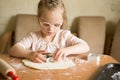 Happy girl with Down syndrome bakes cookies Royalty Free Stock Photo