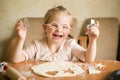 Happy girl with Down syndrome bakes cookies Royalty Free Stock Photo