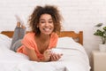 Happy girl drinking coffee, relaxing in bed in the morning Royalty Free Stock Photo