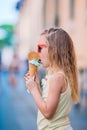 Adorable little girl eating ice-cream outdoors at summer. Royalty Free Stock Photo