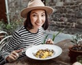 Girl eating a traditional Tuscan delicacy - pasta noodles with fresh mushrooms and truffles. You`ll lick your fingers