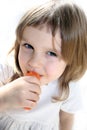Happy girl eats carrot