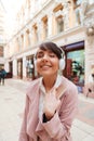 Happy girl enjoying listening to music on a city street Royalty Free Stock Photo